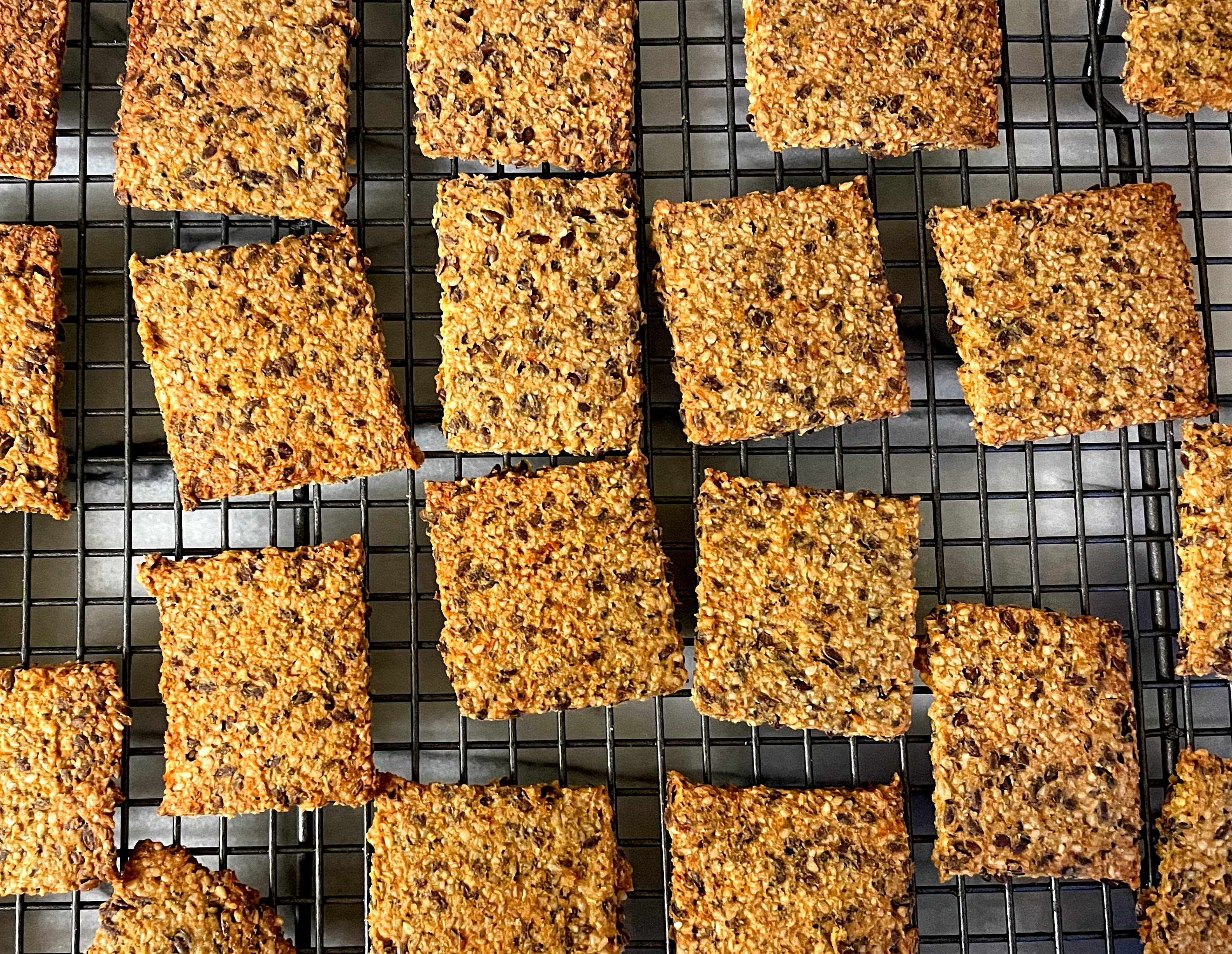 Sun-dried tomato crackers, straight out of the oven and cooling on a wire rack.