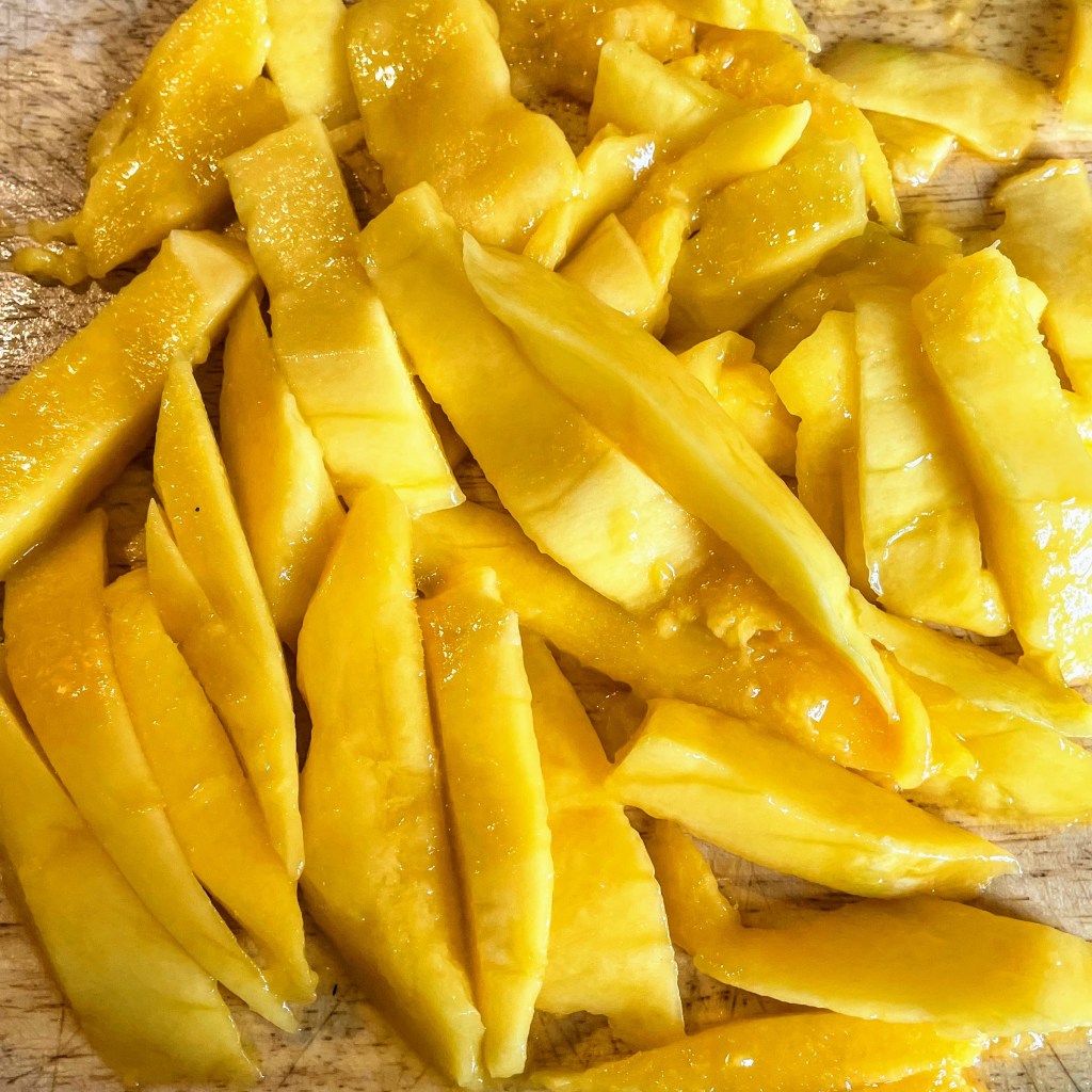 The prepared mango, sliced into rough strips. 